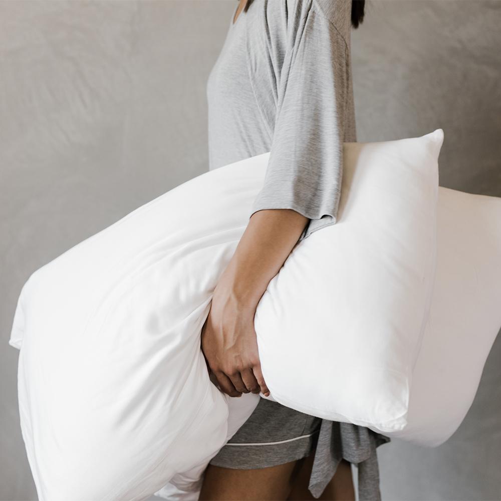 woman carrying silk pillows